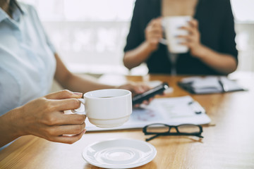 businesswomen working in office with coffee