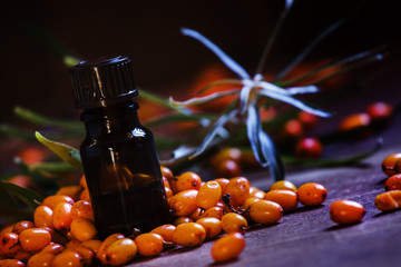 Sea-buckthorn oil for internal use. Vintage wood background, sel