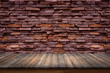 Empty top of wood table on old stone wall background.