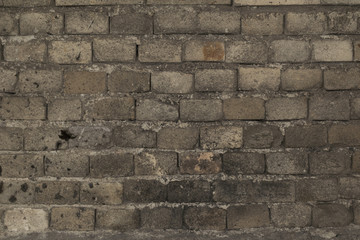 Old broken damaged gray brick wall  abstract isolated background texture