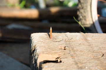BE CAREFUL WITH THE NAIL !! ,PERFORATED OLD WOOD , BLURRY BACKGROUND