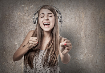 young woman dancing listening to music with headphones