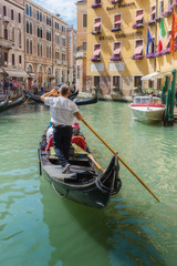 Fototapeta na wymiar Gondolier rides gondola.