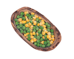 Frozen organic peas and corn in olive wood bowl isolated on white background