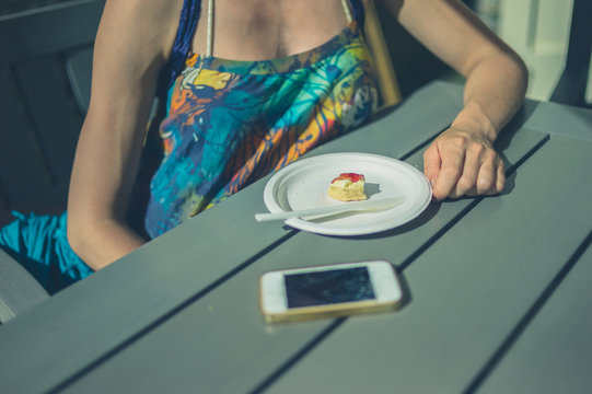 Woman with scone and phone