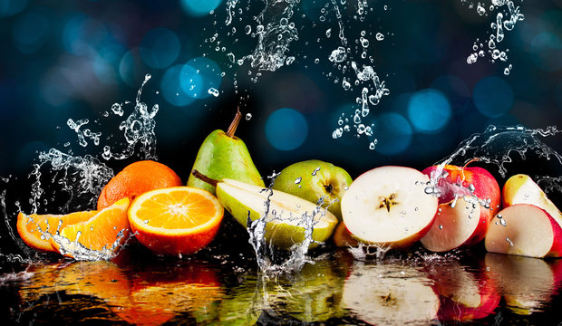 Fototapeta Pears, apples, orange  fruits and Splashing water