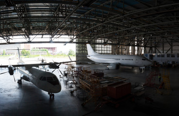 Fototapeta na wymiar Repair and maintenance of passenger airplanes in the aviation hangar
