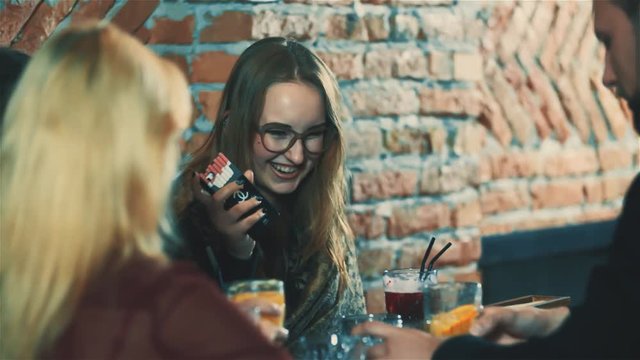 Friends having fun at party bar HD slow motion video. Women and people group laughing and smiling with beverage together