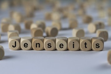 Fototapeta premium Jenseits - Holzwürfel mit Buchstaben