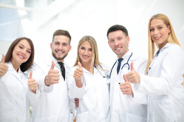 Portrait of doctors team showing thumbs up