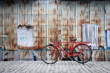 Retro vintage red bike on  street in the old town. Color in blac