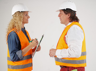 Profile portrait of two civil engineers, a man and a blonde girl, with protective clothes