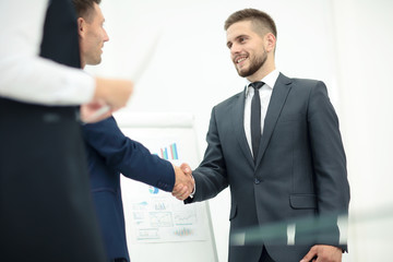 Diversity business team concluding contract with handshake in a 