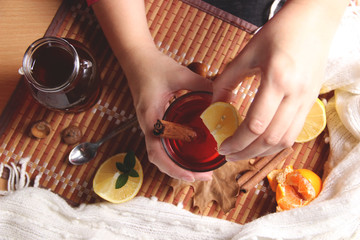Squeezing lemon juice into tea