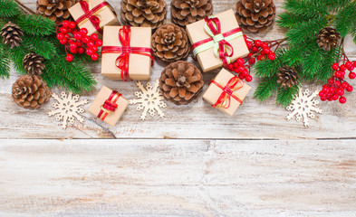 Christmas or New Year background: gifts, colored glass balls, decoration and cones on wooden background