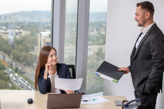 Businessman brought the report to his colleague young Asian girls