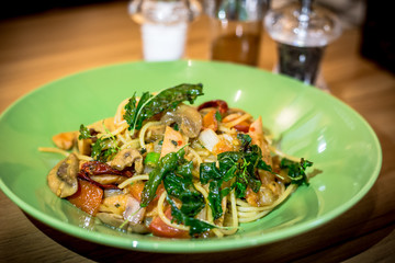 Spicy spaghetti on wooden table
