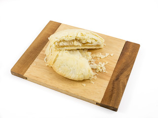 The Taiwanese sun cake (milk butter pastry) on the brown wooden plank.