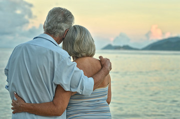 elderly couple rest at tropical beach