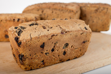 Raisin bread, studio, a loaf of bread on the background of cutting boards and other bread