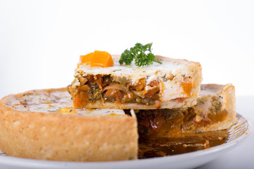 vegetable pie on a plate, white background, studio photo
