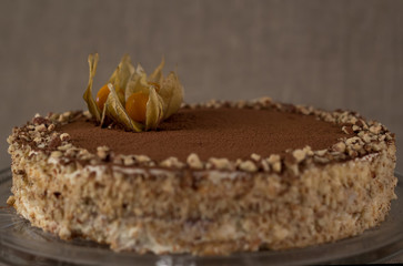 Tiramisu cake with berries on a background of burlap