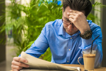 Businessman in the office, reading bad breaking news on a finance