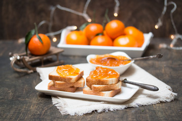Toasted bread with mandarin jam. Winter mood. Selective focus.