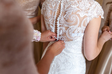 The bride wears a dress