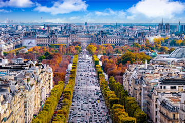 Paris, France - Champs Elysees cityscape. View from Arc de Triomphe. Blue sky with clouds in autumn