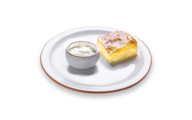 Achma with white sauce on a plate