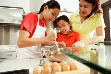 Mother and two daughters in kitchen