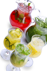 Assorted mojito lemonade berry, lime with mint leaves and ice in a glass