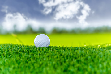 Golf ball on cloud sky background