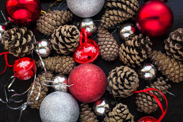Christmas background with red silver balls and pinecone.