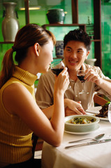 Couple dining in Chinese restaurant, drinking wine