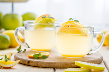 Paleo Apple Hot Christmas Tea in Glass Cups on a Light Wooden Background using for Christmas Wallpaper