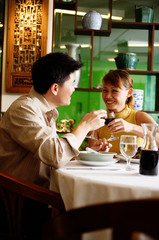 Couple toasting with wine glasses in restaurant