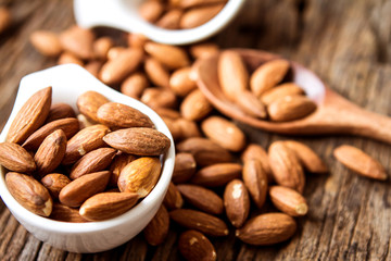 close up Peeled almonds nut  in small white cup 