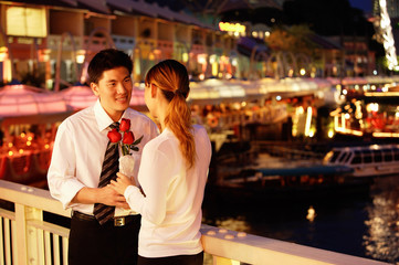 Man and woman standing face to face, woman holding roses