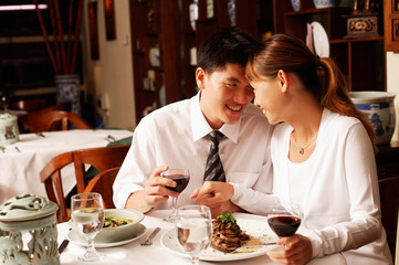 Couple in restaurant, sitting face to face