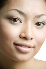 Fototapeta premium Young woman looking at camera, smiling