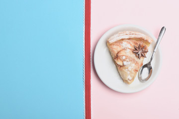 Slice of apple pie on colorful background