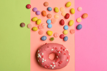 Pink glazed donut on colorful background