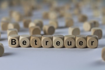 Obraz premium Betreuer - Holzwürfel mit Buchstaben
