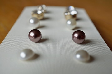 Set of earrings placed in the tray as a symbol of women's accessories, decoration and complements