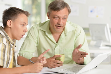 Father helping son with homework 