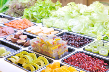 Various vegetables mixed on salad bar.