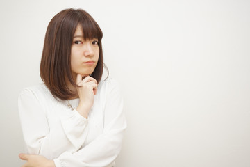 Young woman treating her hair on the white background