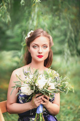 beautiful young woman with a bouquet of flowers in their hands